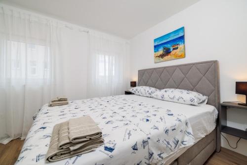 a bedroom with a large bed with a white bedspread at Kuca za Odmor Ena in Jadranovo