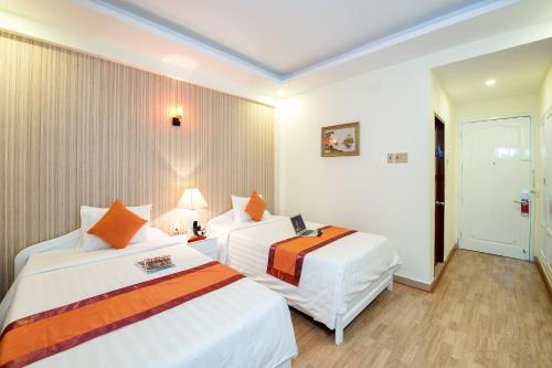 a hotel room with two beds in a room at Palm Beach Hotel in Nha Trang