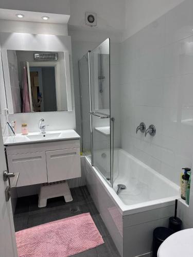 a bathroom with a tub and a sink and a shower at Garden apartment in Ramat HaSharon in Ramat Hash Sharon