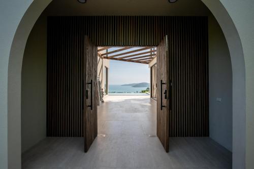 an open door with a view of the ocean through it at Sea Breeze Villa in Amphoe Koh Samui