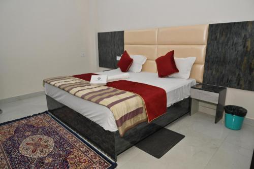 a bedroom with a bed with a laptop on it at Hotel Sai Palace in Masodha