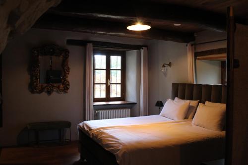a bedroom with a large bed and a window at Cascina Manzoni in Bossolasco