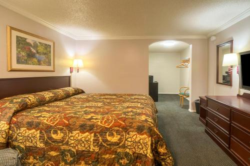 ハンツビルにあるHotel O Haven Inn Huntsville AL US 72のベッドと机があるホテルの部屋