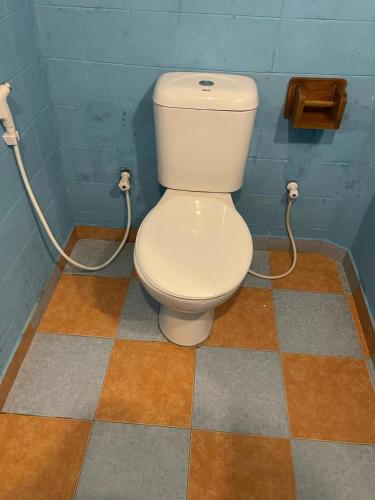 a bathroom with a toilet in a room at Coconut beach in Bentota