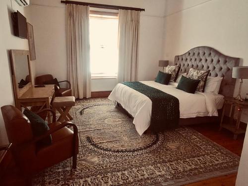 a bedroom with a large bed and a window at Red Ridge Mountain Lodge in Buffelskloof