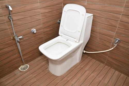 a bathroom with a toilet in a stall at Hotel Sai Palace in Masodha