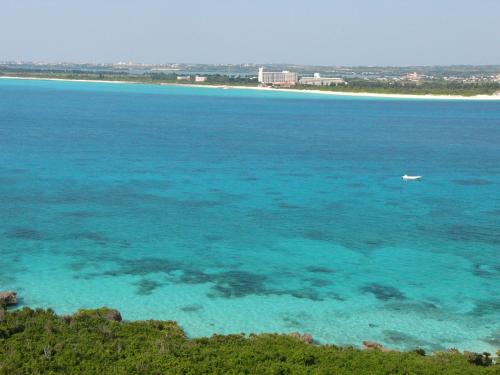 a boat in the water near a beach at Seaside House Nirai in Miyako Island