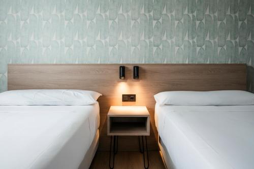 Postel nebo postele na pokoji v ubytování Alora Apartamentos Mérida