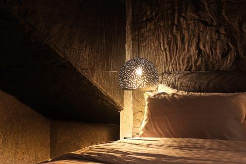 a bedroom with a bed with a lamp on it at اجنحة احسان in Medina