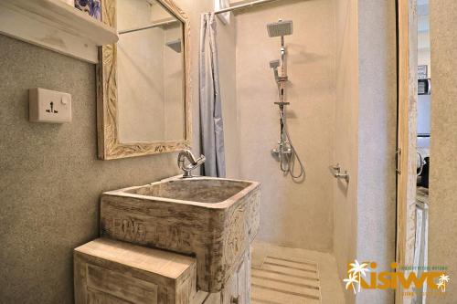 a bathroom with a wooden sink and a mirror at Kisiwa Apartments Watamu - At Ascot Resort - in Watamu