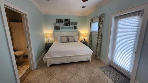 a bedroom with a bed and two windows at Coastal Dunes Escape in Santa Rosa Beach