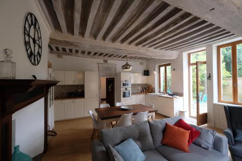 a living room with a couch and a table at Hippolyte House in Beaune