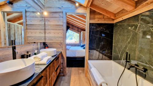 a bathroom with a tub and a sink in a room at Chalet Ski Bob pied de pistes jacuzzi in Font-Romeu