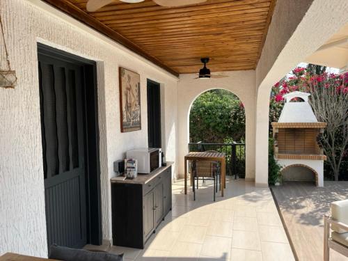 an outdoor patio with an archway and a stove at Villa Leda - The Guest Wing in Paphos City