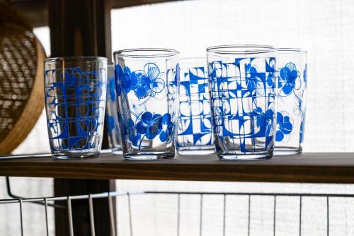 four blue and white glasses sitting on a shelf at GUEST HOUSE Hotori in Otsu