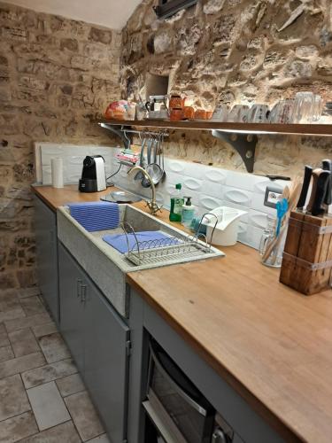 a kitchen with a sink and a counter top at Pedro Country House in Canossa