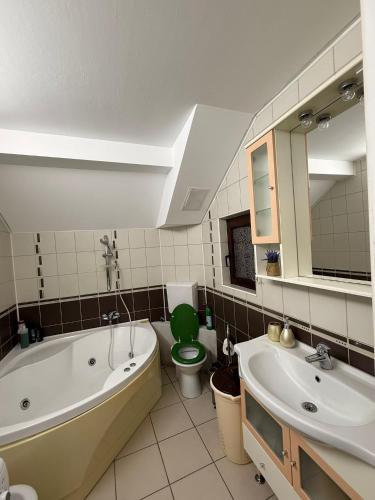 a bathroom with a tub and a toilet and a sink at CENTRUM 22 RESIDENCE Ap II in Sibiu