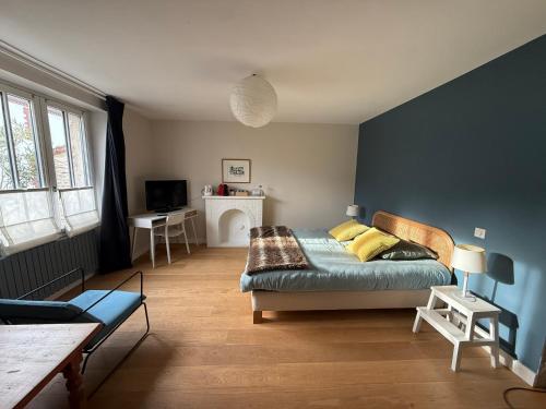 a bedroom with a bed and a table in it at La Pierre Percée - accès digicode in Vertou