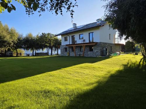 a large white house with a large grass yard at Casa Luigina in Verrayes