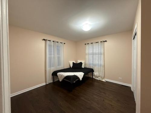 a bedroom with a bed with a pillow on it at Arboretum house in Glen Ellyn