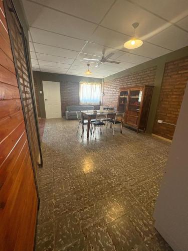 a room with a table and chairs and a couch at Alojamiento cuyum in Rivadavia
