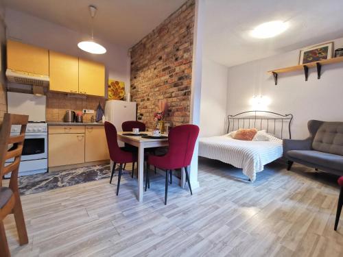 a kitchen and a bedroom with a table and chairs at Apartment in Heart of Užupis - perfect location in Vilnius