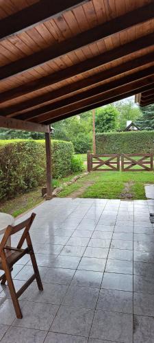 a patio with a bench and a wooden roof at Posta Magica in Villa Ciudad Parque