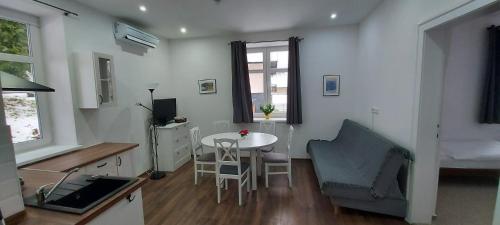 a living room with a table and a chair at Ubytování v soukromí - MERAN in Svoboda nad Úpou