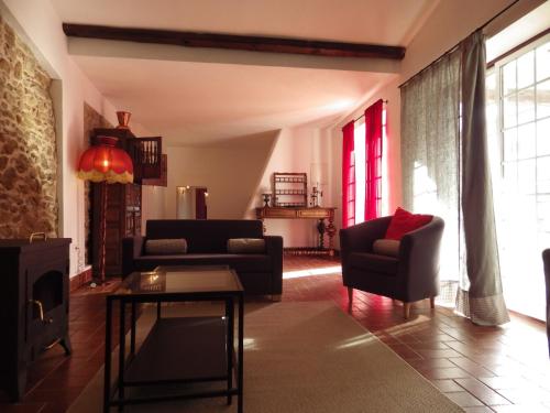 a living room with a couch and chairs and a table at Casa de Nossa Senhora da Conceição in Gavião