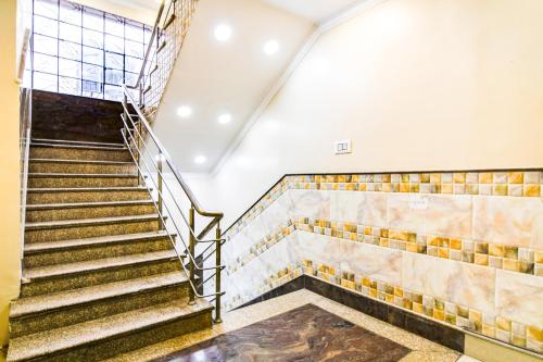 an empty room with stairs in a building at Hotel O Barsana in Pātipukur