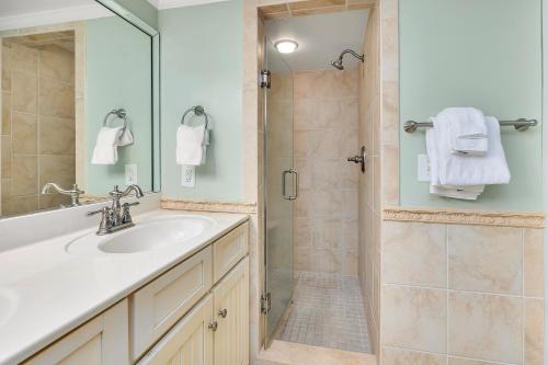 a bathroom with a sink and a shower at Beach Club #414 in Saint Simons Island