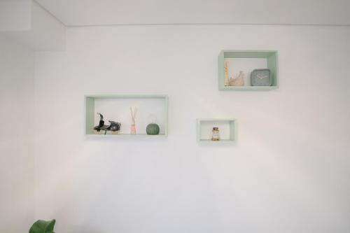 a white wall with four pictures on it at Apartamento do Sol, Lobão 