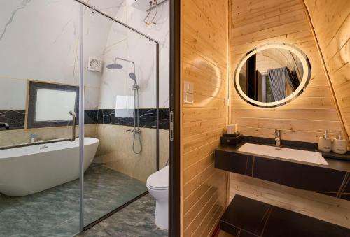a bathroom with a toilet and a sink and a mirror at TamCoc Moon An Bungalow & Cafe in Ninh Binh