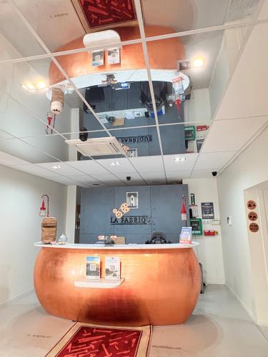 a museum with a large wooden counter in a room at Hôtel La Fabrique in La Rochelle
