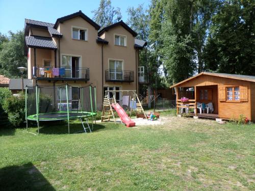 a house with a playground in front of it at Bea in Międzywodzie