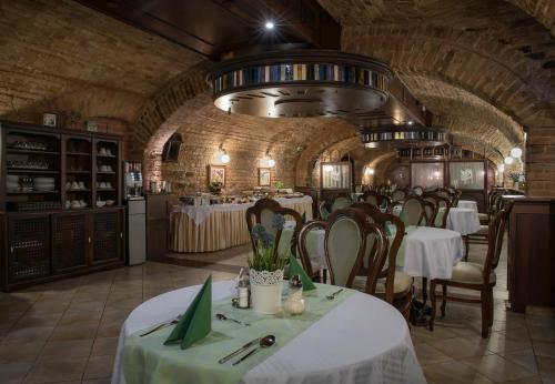 a dining room with tables and chairs in a building at Cotton House Hotel Budapest in Budapest