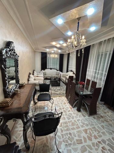 a large living room with a table and chairs at Toum's Apartments 2 in Amman
