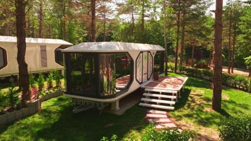 a gazebo with a bench in a yard at Harmony Green Village Resort in Mahmudiye