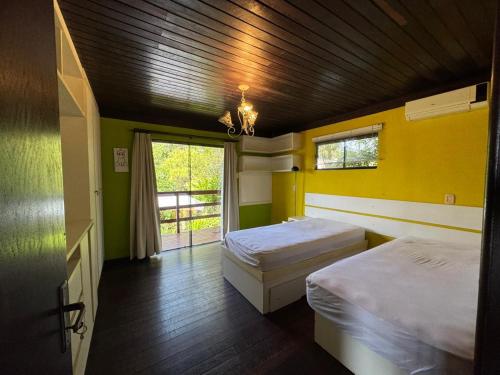 Postel nebo postele na pokoji v ubytování Temporada de Casa apenas 500 metros da Praia da Gamboa SC