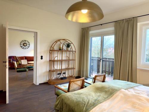 a bedroom with a bed and a living room at Strumpfburg by Dollop Living in Kramsach