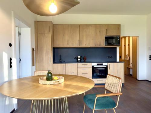 a kitchen with a table and chairs in a room at Strumpfburg by Dollop Living in Kramsach