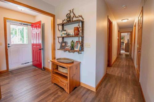 a hallway of a home with a red door at Robbins' Mountain Retreat in West Thornton