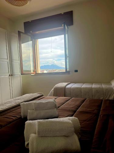 a bedroom with a bed with towels on it with a window at B&B La Rotonda in Naples