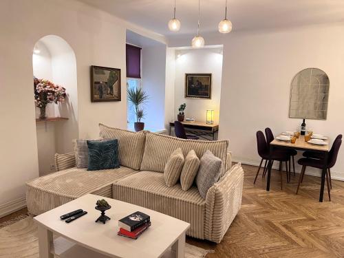 a living room with a couch and a table at Reval Residences Old Town in Tallinn