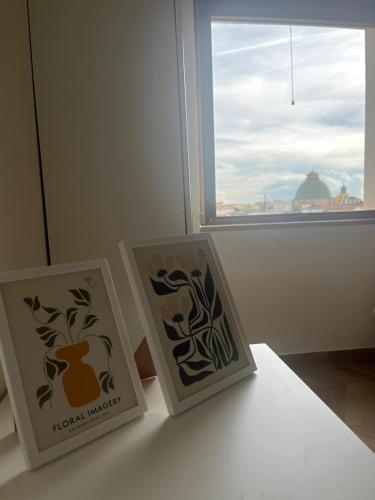 three cards sitting on a table in front of a window at B&B La Rotonda in Naples