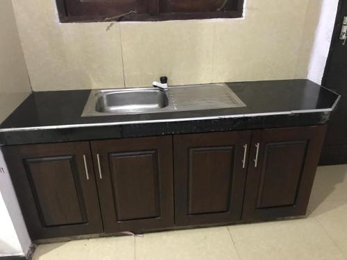 a kitchen counter with a sink in a room at Golden Gate Ways Villa in Hikkaduwa