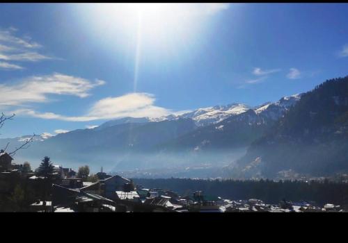 a view of a city with mountains in the background at ishaan resorts near mall road 10 min walk and big parking in Jāmb