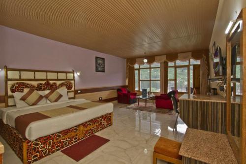 a bedroom with a bed and a living room at ishaan resorts near mall road 10 min walk and big parking in Jāmb