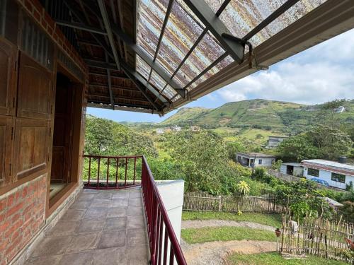 a balcony of a house with a view of the mountains at Nirvikalpa vagamon in Vagamon