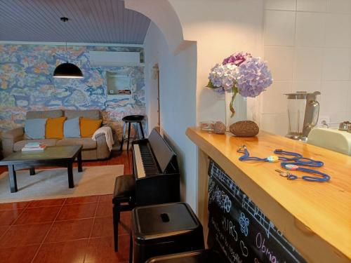 a kitchen with a counter with scissors on top of it at Casa Sol Nascente in Ponta Delgada